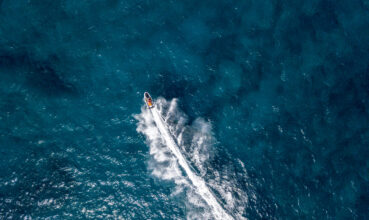 Aerial view of a jet ski cruising at full speed. Fun and holidays, water sport. Sea and waves
