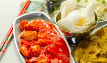 Chinese set, chicken curry, sweet and sour chicken served with egg fried rice, vegetable spring rolls, and prawn crackers, china food