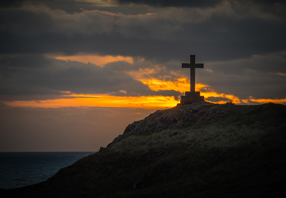 Cross at sunset on Ynys Llanddwyn, Anglesey