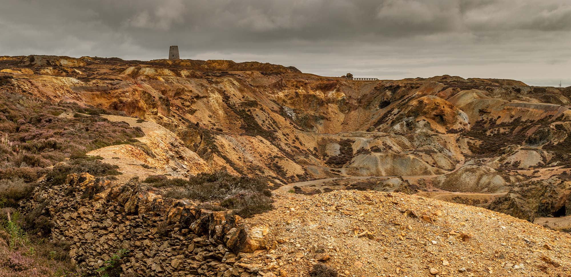 The orange and brown landscape of the disused Parys Mountain copper mine, Anglesey, North Wales.