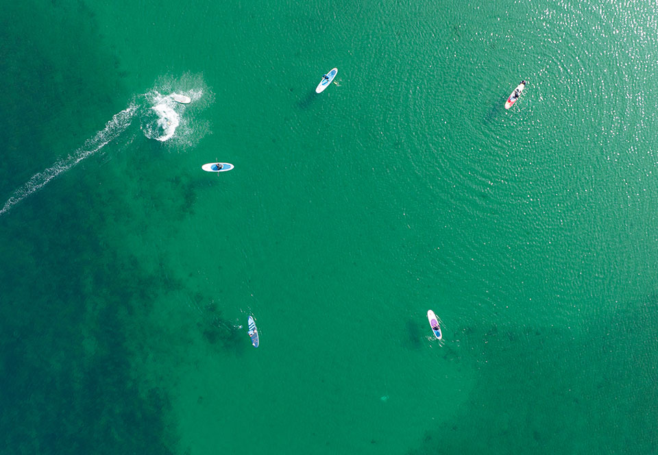 Paddle boards from above in Rhosneigr, Anglesey