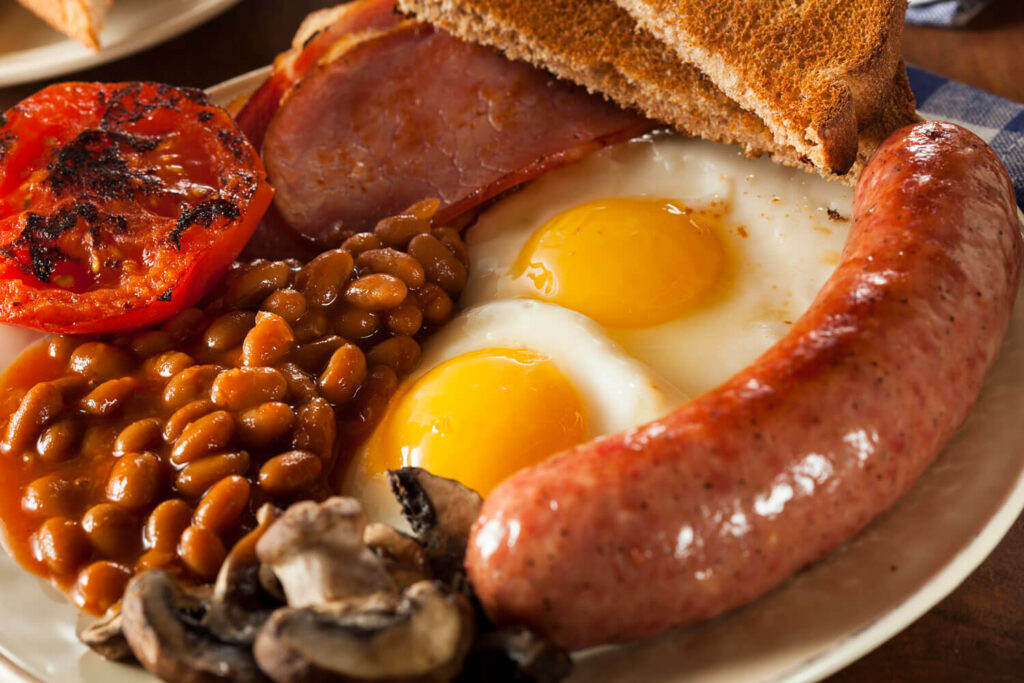 Traditional Full English Breakfast with Eggs, Bacon, Sausage, and Baked Beans