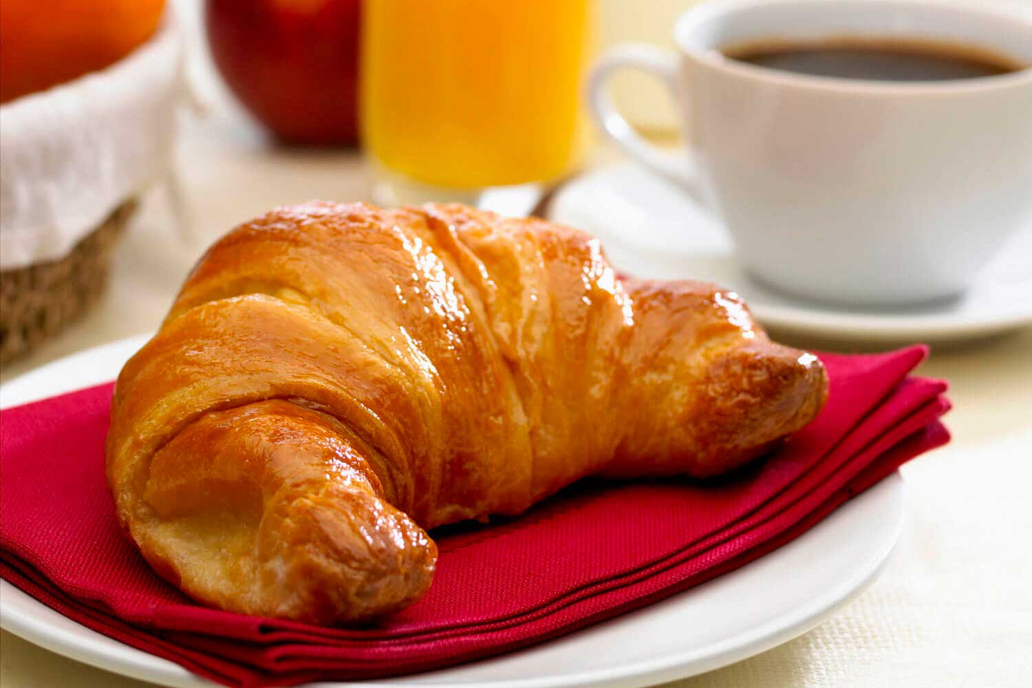 continental breakfast with milk coffee orange juice and croissant